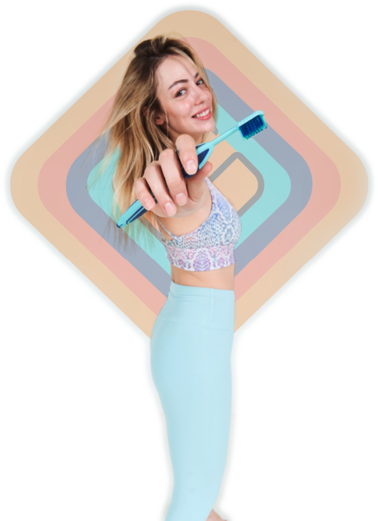 Woman wearing yoga clothes and holding a Grippi toothbrush